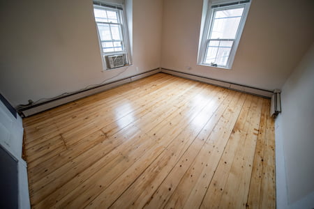 Replace carpet with hardwood in rental unit