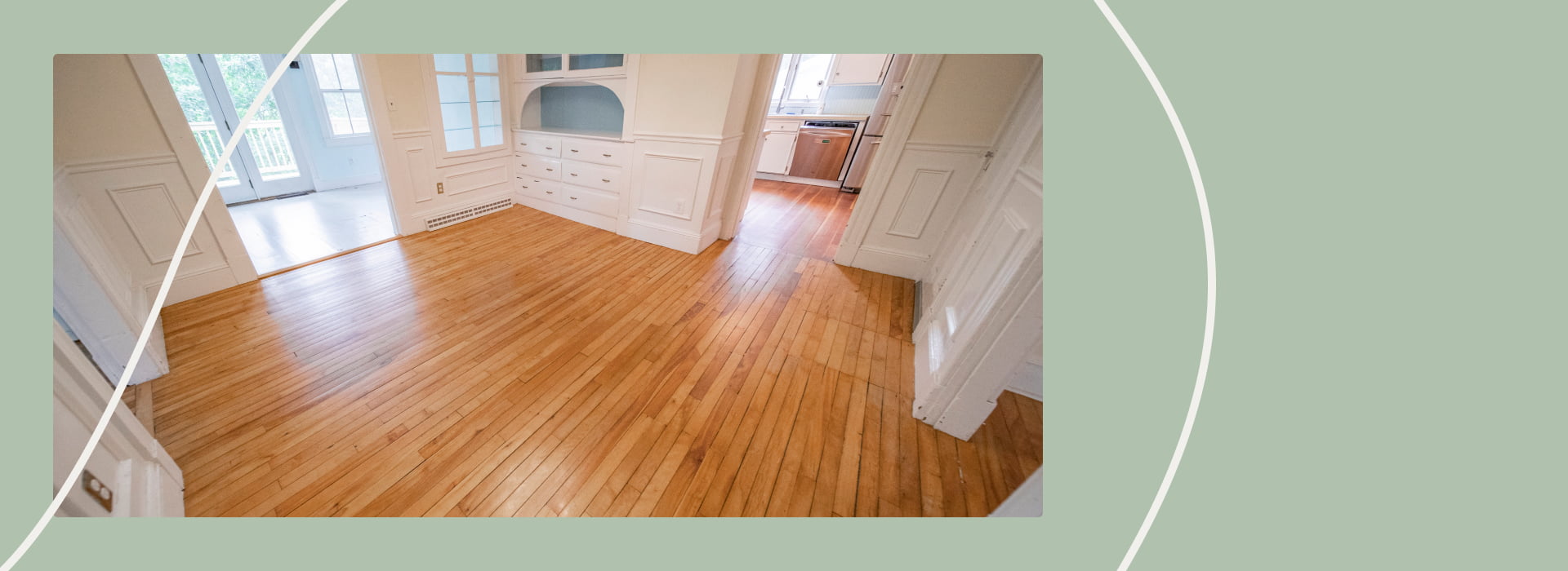 Refinished hardwood floors in a bright, open dining area with white walls and built-in cabinetry