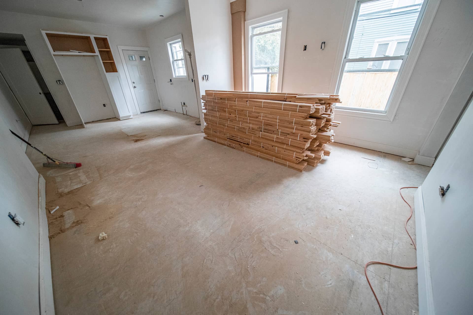 New hardwood installation replacing damaged flooring in a bright living space.